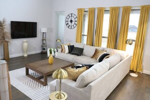 The bright and comfortable living room is designed for relaxation, ideal for long stays. After shopping at Walmart Supercenter or enjoying a meal at Basil Cafe, this space provides the perfect spot to relax and enjoy time with family