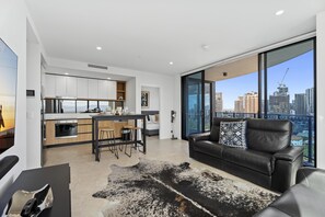 Fully equipped modern kitchen is right next to the living area