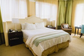 Premier suite with a luxurious king bed, elegant decor, and ample natural light for a truly relaxing stay.