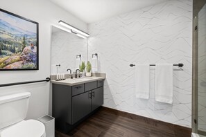 The primary bedroom features a King size bed, walk-in closet, & ensuite bathroom
