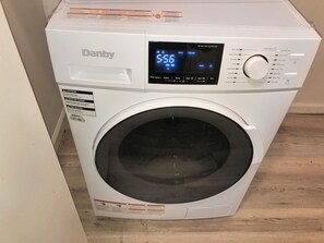 The laundry area includes a modern-ventless washer-dryer unit.  