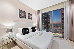 Stylish Bedroom: Enjoy stunning city views as you unwind in luxury and modern comfort!