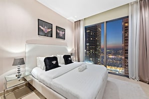 Stylish Bedroom: Enjoy stunning city views as you unwind in luxury and modern comfort!