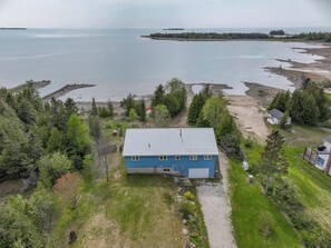 Bird’s-eye view of the cottage nestled along Lake Huron’s edge. A perfect home base for exploring the Bruce Peninsula and enjoying waterfront serenity.