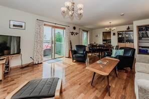 Open-concept layout with a cozy living room and adjacent dining space—ideal for unwinding together after a day at the beach or hiking the Bruce Trail.