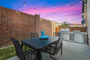 Feel free to make use of this outdoor BBQ grill and enjoy a tasty meal on the furnished backyard patio under the twinkling glow of the string lights.