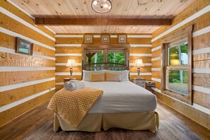 Cozy nights rest in any of the five bedrooms - this is the main level king suite