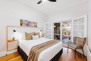 The first bedroom in the first cottage—Kareela—has a lovely outlook over the garden and offers a comfortable queen-sized bed.
