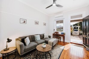 The open-plan living room in the second cottage—Kialla—flows seamlessly to the backyard, enhancing your indoor-outdoor experience.
