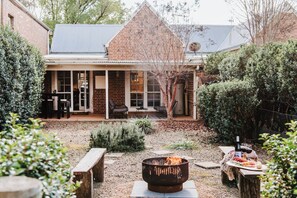Experience cosy gatherings around the fire pit in the first cottage—Kareela, complemented by benches for shared moments under the stars.