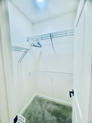 Walk-in closet, has iron and ironing board placed inside