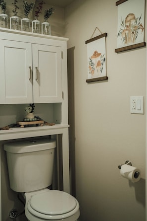 Cute bathroom with full shower.