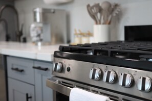 Modern kitchen with gas stove and stainless appliances, perfect for home chefs.