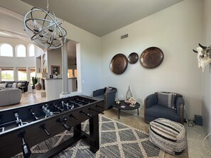 The game room is open to the rest of the house, so you won’t miss a beat