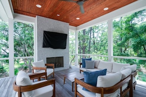 Covered back porch with large wall mounted Smart TV