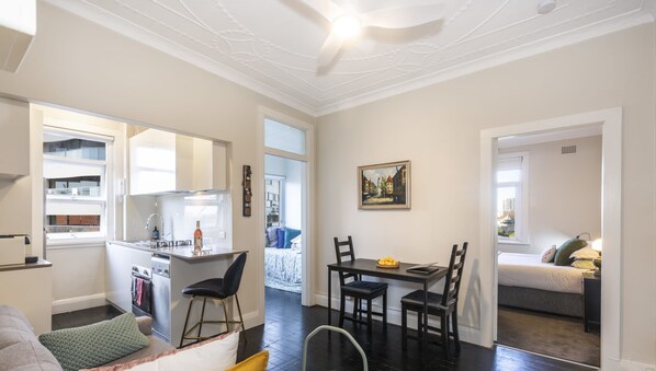 Open plan living and dining area with dark floorboards