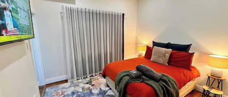 Wall mounted flatscreen smart TV in bedroom