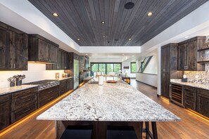 The oversized kitchen island is a great gathering point bridging the dining area and living room.