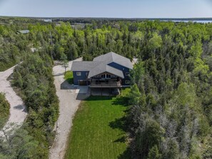 Nestled within lush greenery, Changri-la offers a peaceful retreat. The aerial perspective showcases its prime location, surrounded by a vast, well-maintained lawn and natural beauty, perfect for nature enthusiasts seeking tranquility and seclusion.
