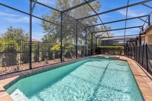 Dive into relaxation in your private screened pool oasis, surrounded by lush greenery and tranquility.