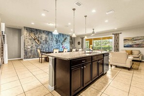 Fully equipped with stainless steel appliances, ample counter space, and a large island, it's perfect for creating culinary delights for your whole crew.