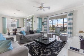Bright and airy living room with pool views, perfect for relaxation and gatherings.