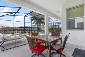 Relax on the private patio with a pool view, perfect for outdoor dining and enjoying serene pond views.