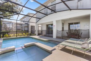 Relax in your private screened pool oasis with a jacuzzi and outdoor dining area, perfect for sunny days and starry nights.