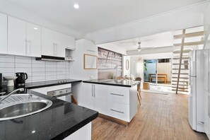 The effortless kitchen provides ample space to cook up a storm, with long bench space and generous cabinet storage. 
