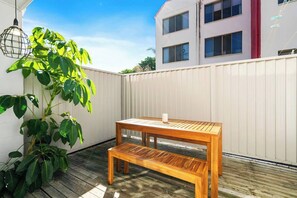A charming outdoor deck has a picnic style wooden table that sits under open skies, so you can enjoy meals in fresh air and sunshine when suitable. 
