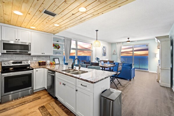 Spacious luxury awaits in this corner unit with wide beach and ocean views