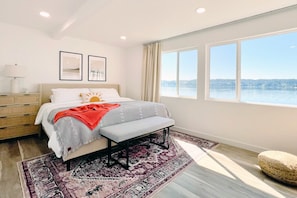 Soothing bedroom with panoramic Hood Canal views and the calming sound of waves crashing outside.