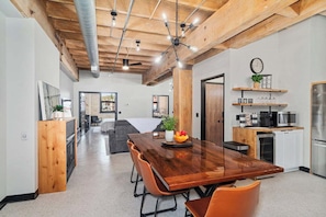 Step into your serene, sunlit living area, where a spacious table for eight invites you to unwind and enjoy cozy meals or peaceful gatherings. It’s the perfect balance of light and warmth, creating a calm and inviting atmosphere.