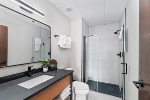 The master bathroom boasts a luxurious, tiled shower that offers the ultimate spa-like experience. The walls are beautifully adorned with sleek, high-quality tiles, creating a clean, modern aesthetic that enhances the feeling of serenity. But what truly elevates the experience is the massaging showerhead. Equipped with multiple settings, it allows you to customize your shower e...
