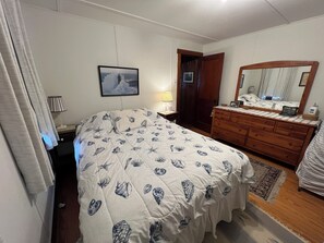 Primary bedroom with queen bed; at far right is (folded) extra single bed.
