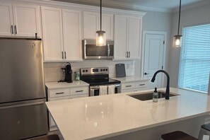 Fully stocked kitchen has ample cookware, dinnerware and glassware  for quick food on the run or full meals.
