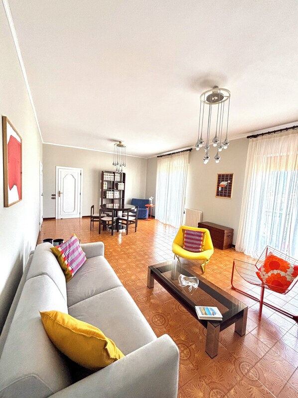 Living room 34 m2 divided into relaxation area with double sofa bed, armchairs, bookcase and 55" smart TV with stereo and Dining area with extendable 6-seater table.