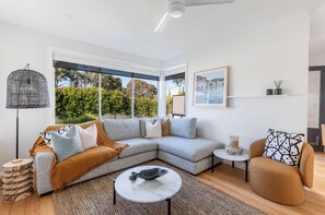 Living room with plushy sofa and ceiling fan