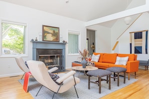 The open-concept living area has pops of color and character.