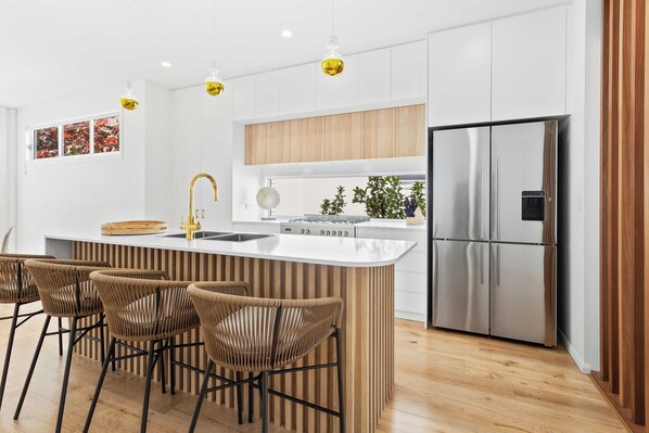 Modern Kitchen ready for cooking a gourmet meal, complete with 4 stools to keep it social.