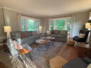 Living room with enough seating for your group as well as a 65 in Smart TV.  Feel free to log into your streaming apps during your stay.