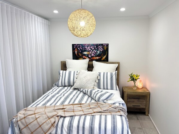 Luxurious sheets, spare blanket, blackout curtains for a serene, restful night.