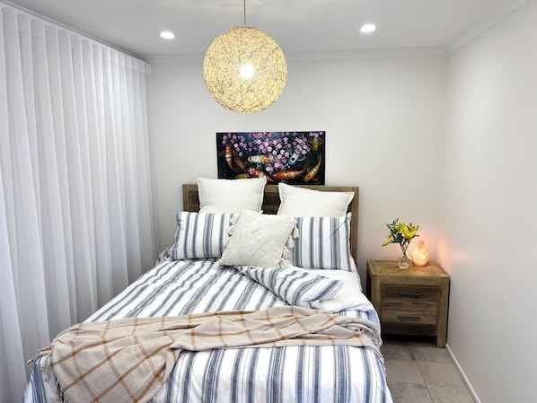 Luxurious sheets, spare blanket, blackout curtains for a serene, restful night.