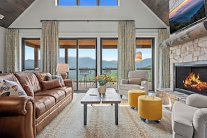 The living room at this two bedroom cabin enjoys unparalleled views of Mt LeConte and the Great Smoky Mountains National Pak