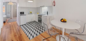 The Dining Area And Kitchen Of Heart Of Old Town Apartment 2 By Ourmadeira