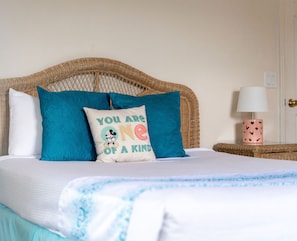 The tranquil queen suite offers an attached bath, TV, & balcony access