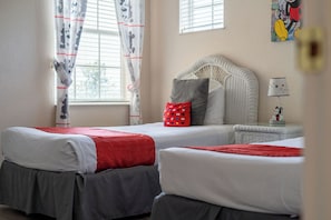 A pair of cozy twin beds & TV await in the final bedroom retreat