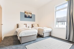 Bedroom 1: two single beds with fresh linen and towels provided.