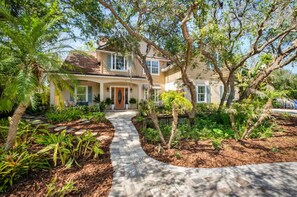 Gorgeous main home is tucked back from the road and is complimented by greenery!