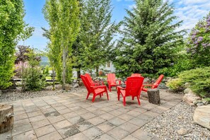 Private backyard oasis with a fire pit & Adirondack chairs